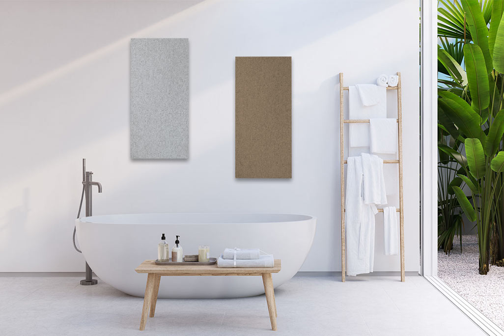 Bright bathroom with a white bathtub and a white wall with two rectangular acoustic elements in beige and light gray.
