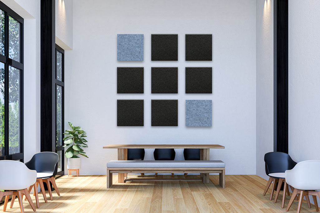 soni COLOR RD - Akustikelement aus PES-Vlies mit farbiger Filz-Oberfläche Bright café with white walls, a high ceiling, black and grey furniture, complemented by square, colored acoustic elements on the wall.