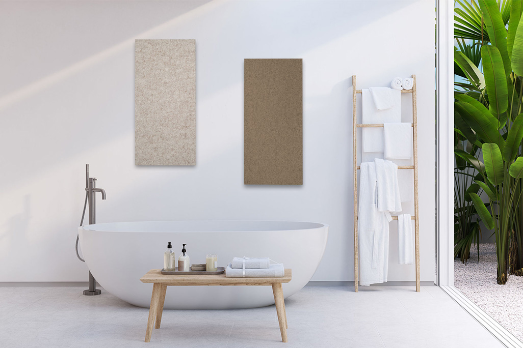 Bright bathroom with a white bathtub and a white wall with two rectangular acoustic elements in beige and greige.